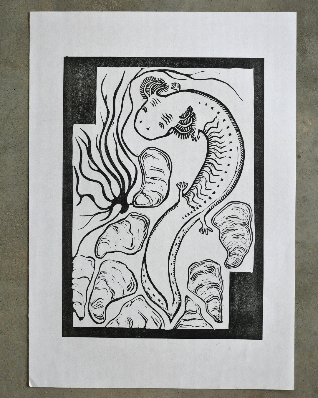 Black ink linocut art print of a salamander on a white background
